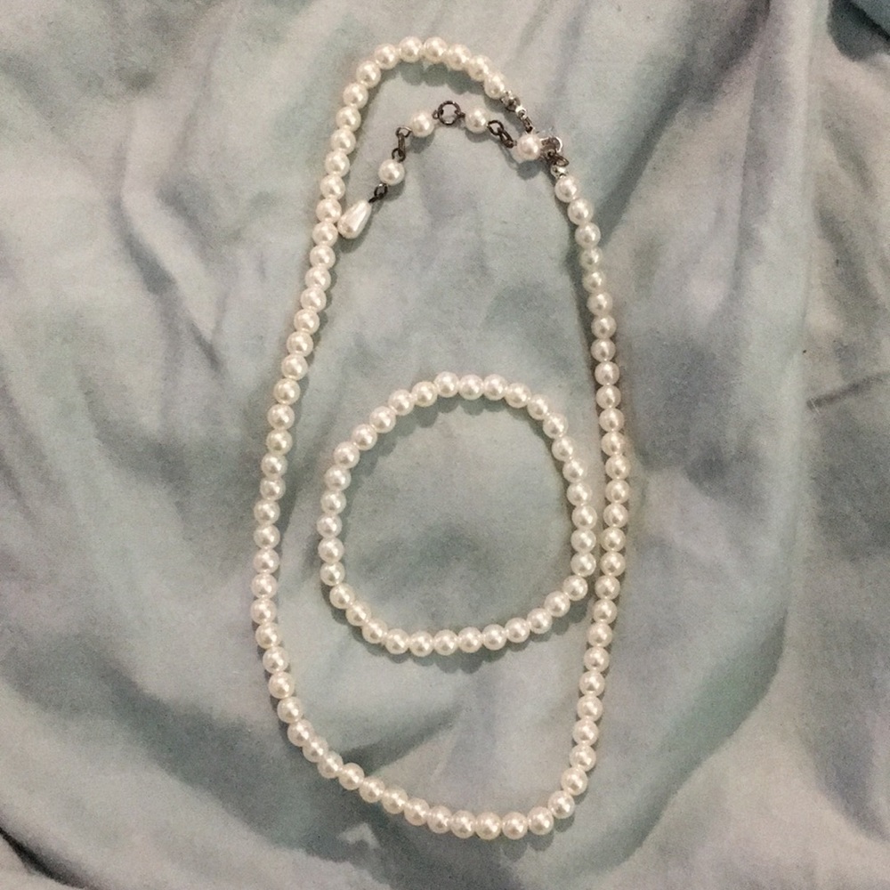 Costume pearl necklace and pearl bracelet.
